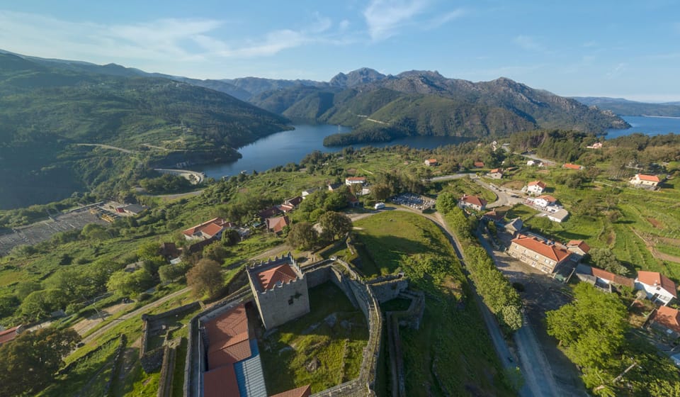 An aerial view of Lindoso, with its historic castle, village, and stunning reservoir.