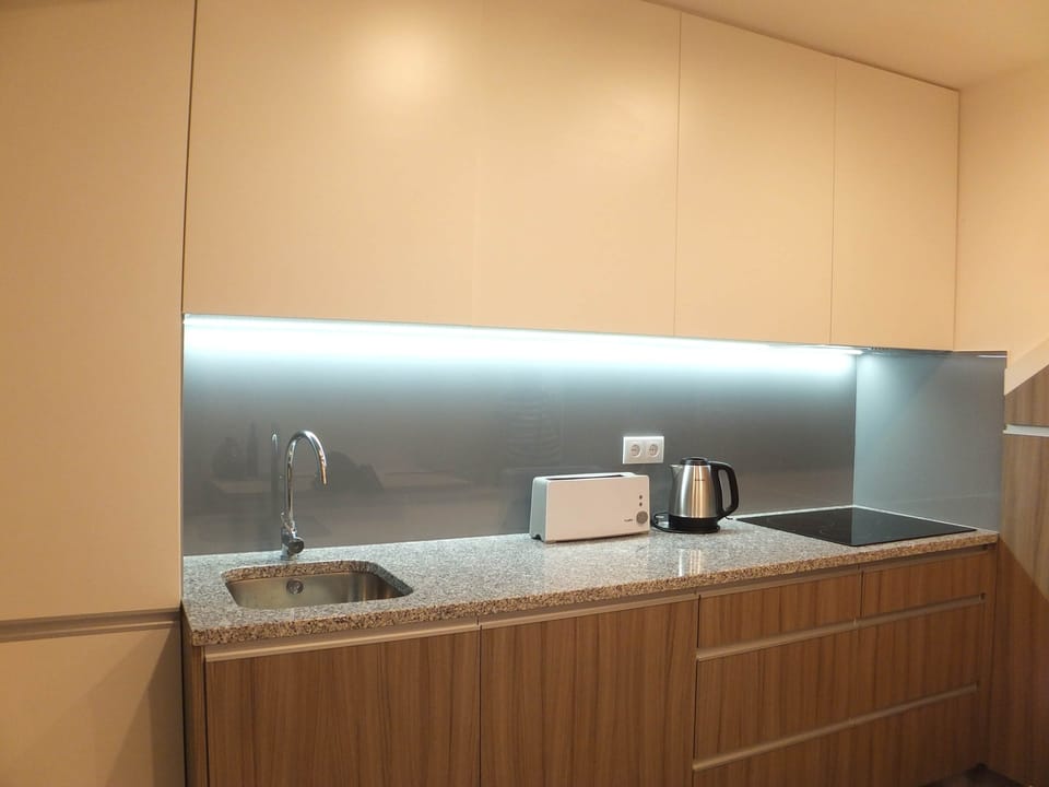 The sleek, modern kitchen is fully equipped for your convenience.