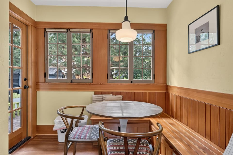 Just next to the kitchen is this adorable dining nook with backyard views