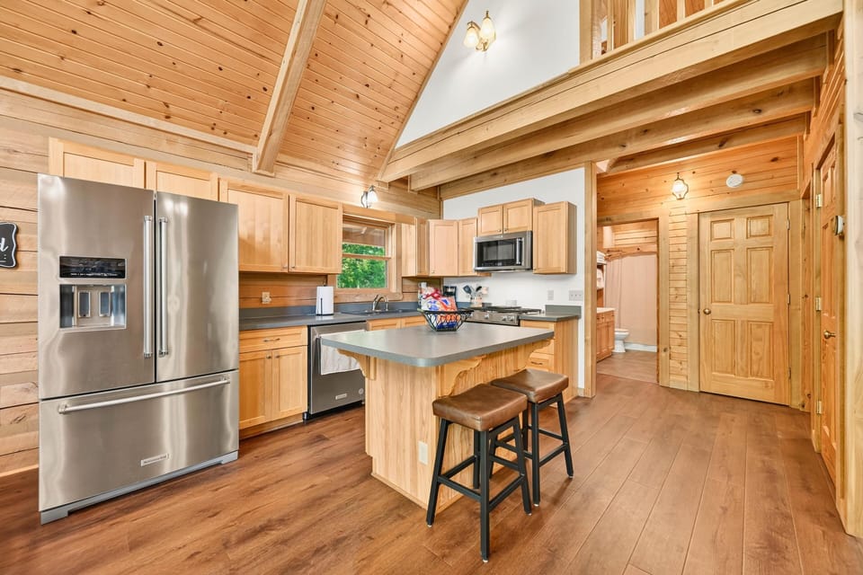 Spacious kitchen with modern appliances and cozy wood accents