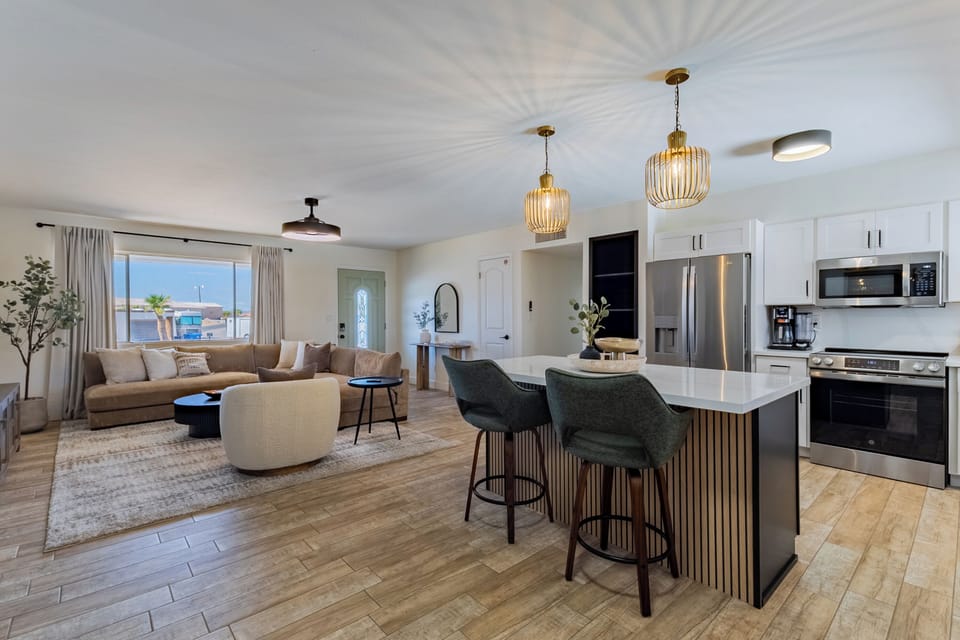The open floor plan seamlessly connects the kitchen, island, and family room