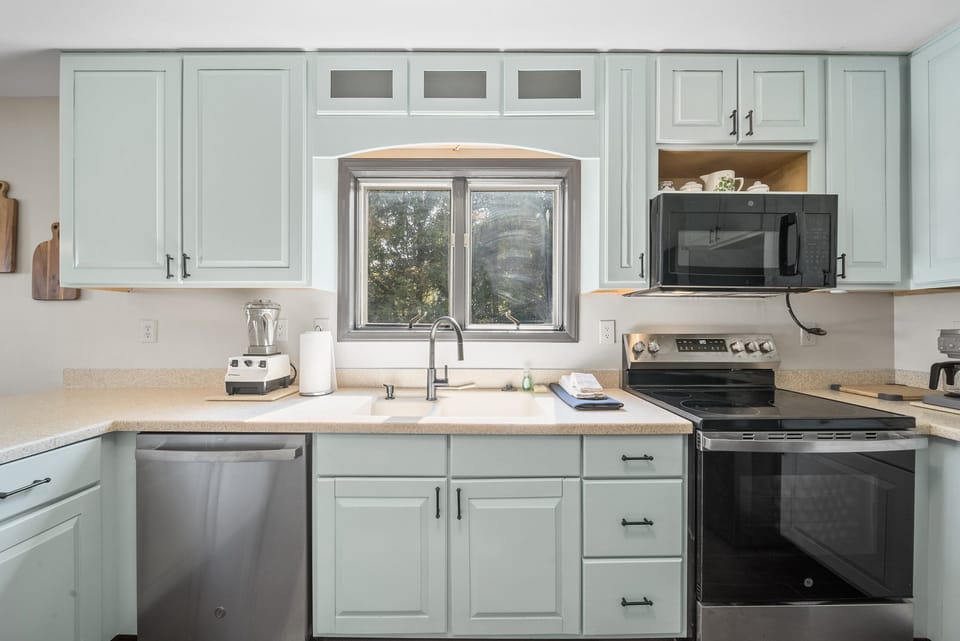 Well Equipped Kitchen with Custom Cabinets and Corian Countertops