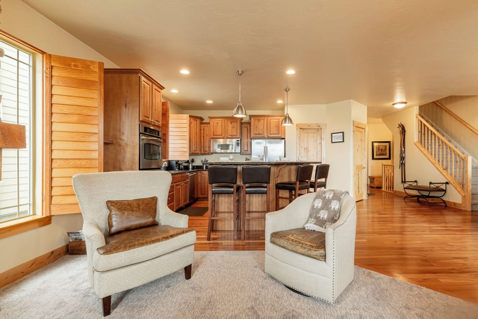 Open-concept living area with seating and kitchen view.