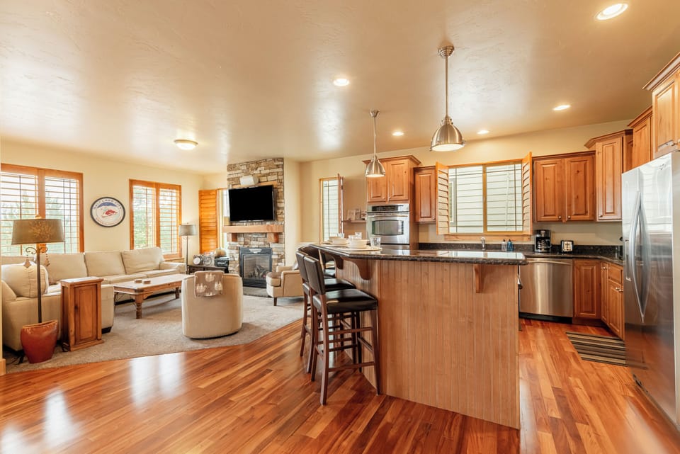 Spacious kitchen with bar seating and modern appliances.