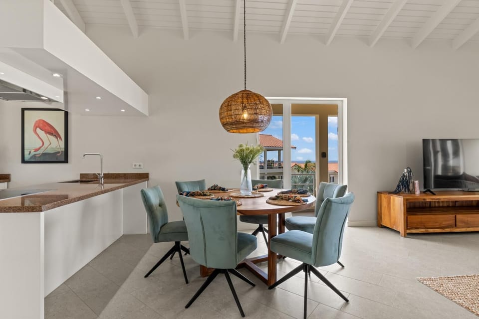 Contemporary dining space with indoor-outdoor flow and bright natural light.