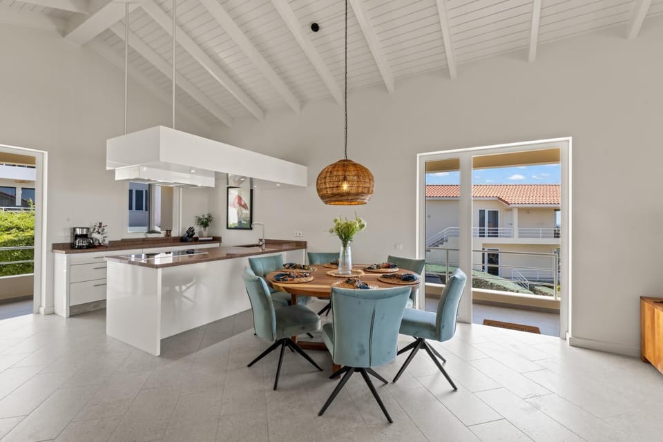 Sleek kitchen with modern appliances and breakfast bar, perfect for cooking at home.