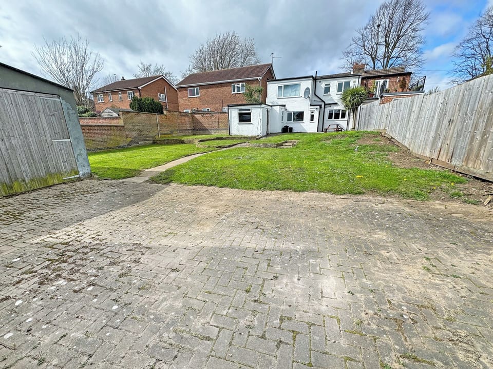 Exterior of the property as viewed from the rear, offering off-road gated parking and access to the property | Riverside Cottage, Spalding