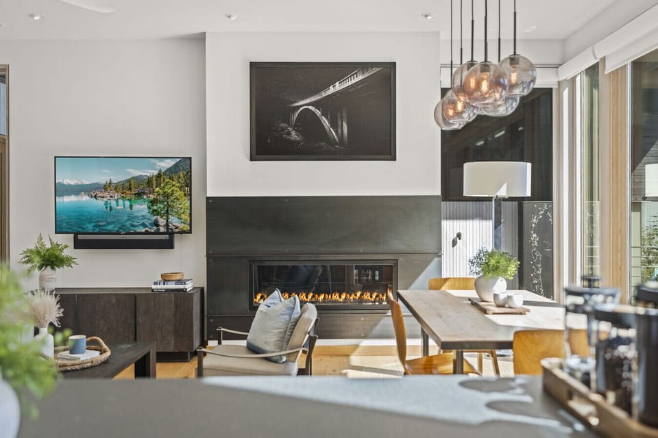 Living Area: Modern space with a sleek fireplace, TV, and inviting natural light! Perfect for relaxation.