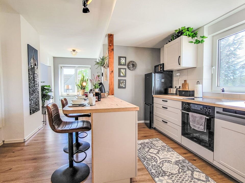 Furniture, Countertop, Interior Design, Kitchen, Kitchen Appliance, Flooring, Cabinetry, Major Appliance, Wood, Floor