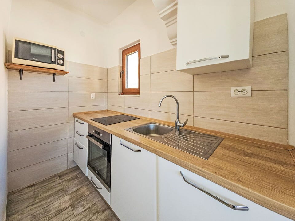 Flooring, Wood, Floor, Countertop, Interior Design, Kitchen, Cabinetry, Major Appliance, Home, Kitchen Appliance