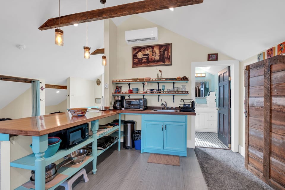 Upstairs kitchen w/ breakfast bar & vintage-inspired touches.
