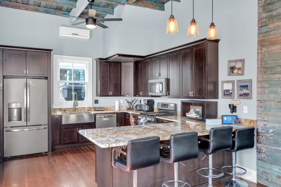 Chef's kitchen w/ a marble island — perfect for cooking up a group meal.
