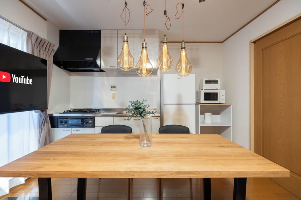 Apartment, Balcony | Living area | 65-inch flat-screen TV with digital channels