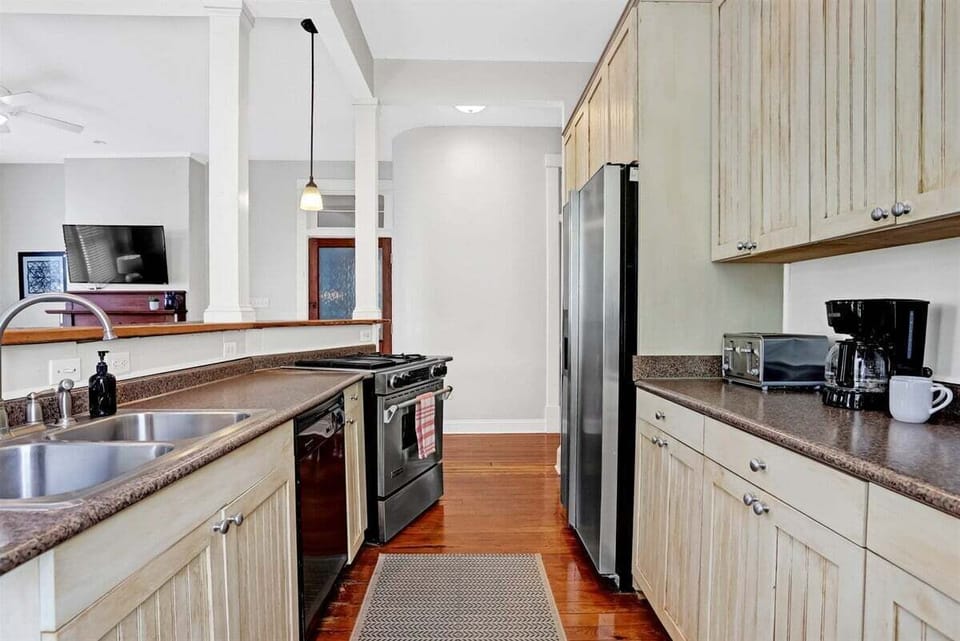 Bright and inviting kitchen with cream cabinetry and ample space to cook and gather.