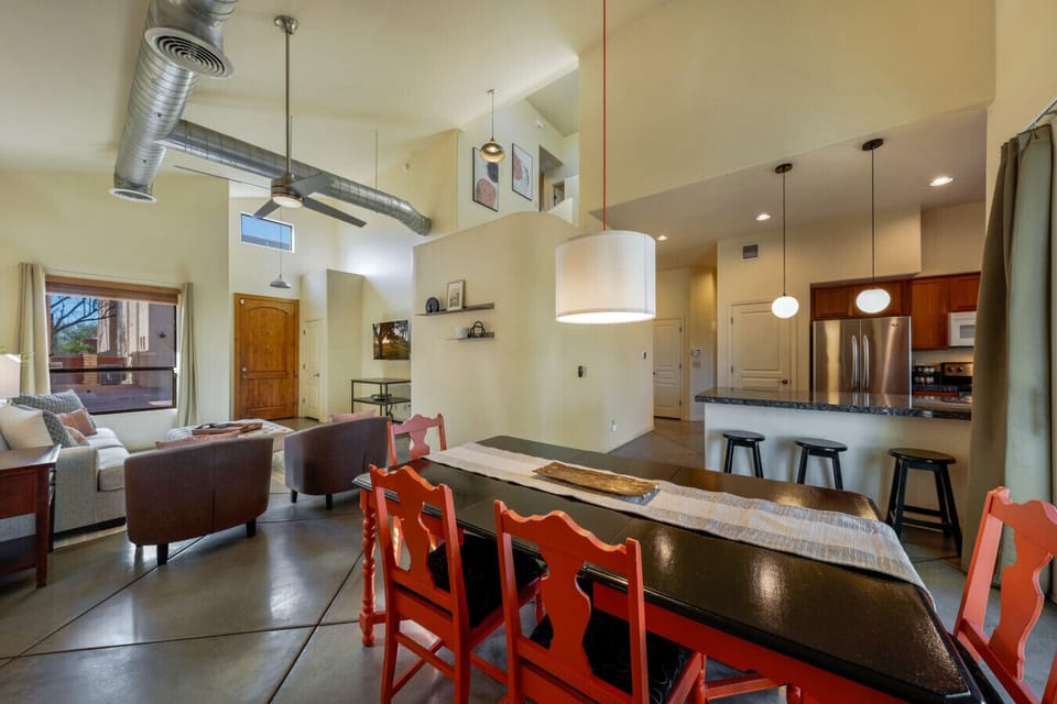 Bright and spacious open living-dining area with stylish furnishings, modern décor, and lofty ceilings for a welcoming feel