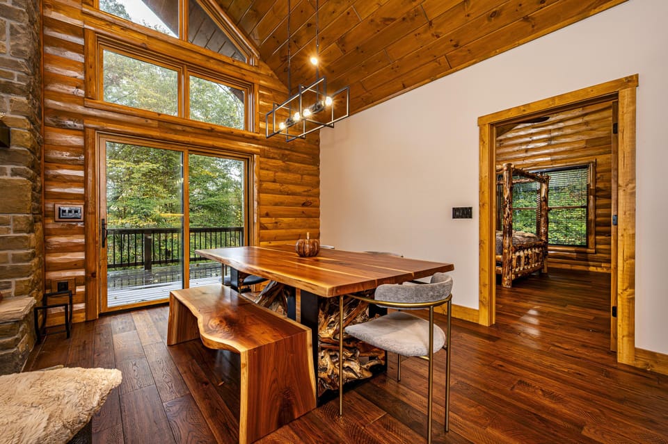 Cozy log cabin dining area with forest views and rustic charm