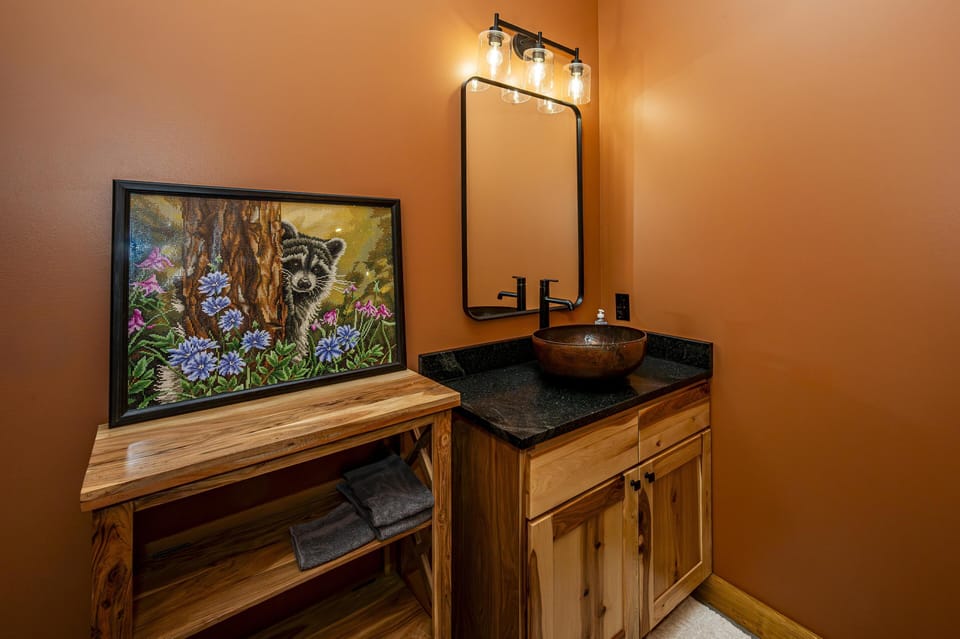 Cozy bathroom with rustic wood vanity and vibrant artwork
