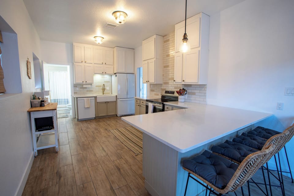 Oven, stove, dishwasher and full-size refrigerator, blender and coffee station.