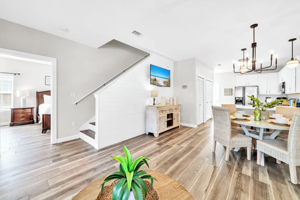 Bright, open living space flows seamlessly from your dining area to kitchen, with warm wood floors and modern lighting creating the perfect atmosphere for meals.