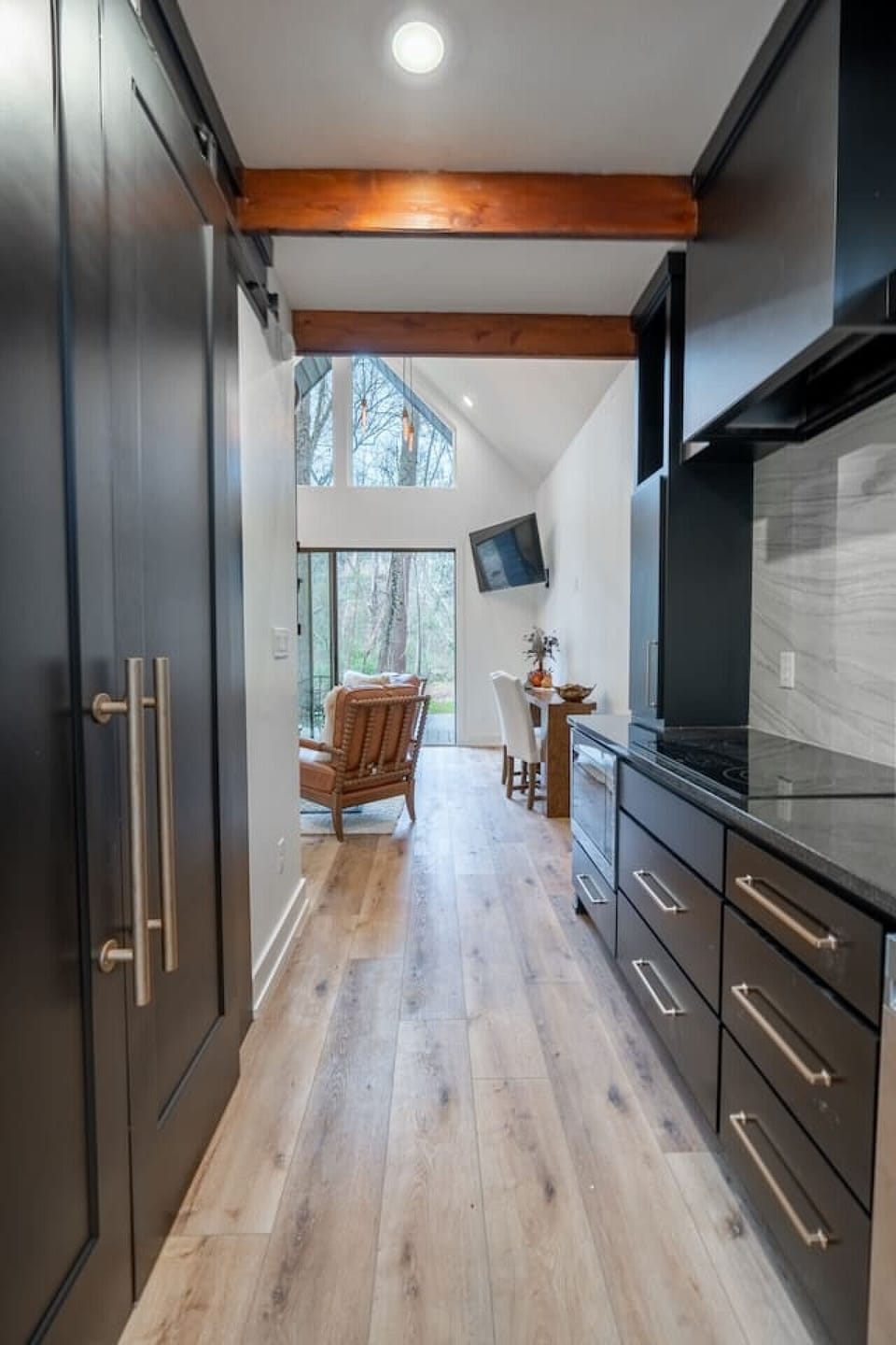 Open-concept layout connecting the kitchen and living area with natural light throughout.