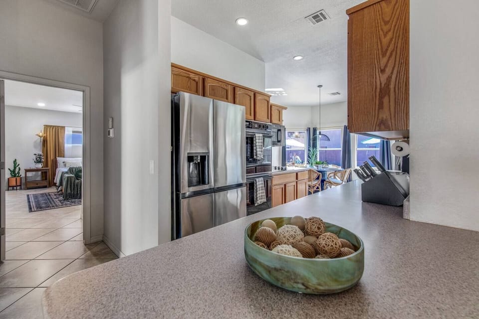 Fully equipped kitchen with modern appliances, including air fryer, blender, coffee maker, and electric stovetop.