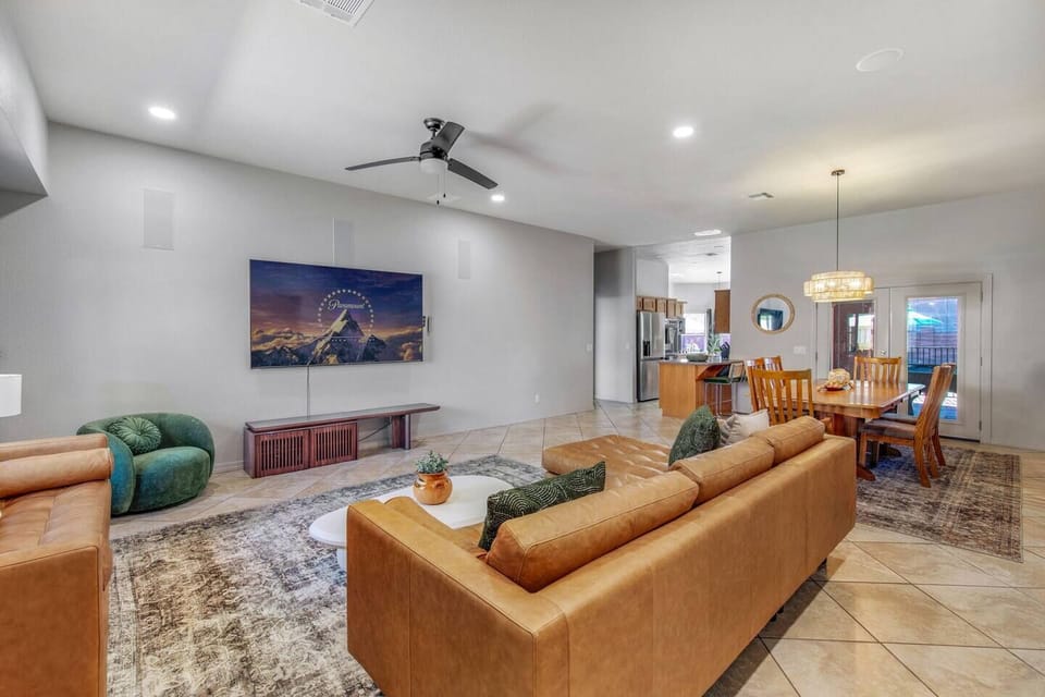 Open-concept living and dining area with a smart TV, cozy sectional, and queen sofa sleeper.