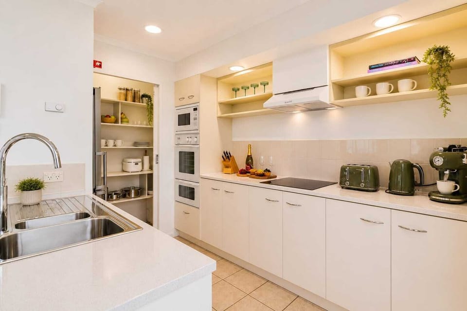 Modern, fully equipped kitchen featuring quality appliances, coffee machine and everything you need to cook at home.