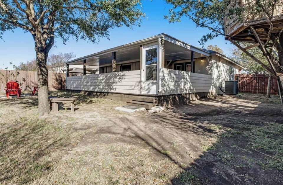 Charming exterior with spacious deck and shaded outdoor areas