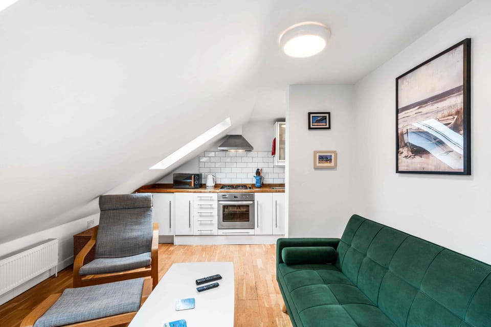 Modern design with sofa seating and fresh décor in the open-plan area.