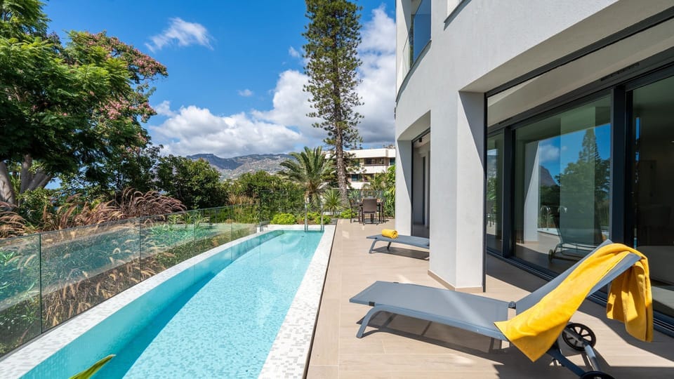Enjoy sunny days by the pool, relax on loungers, or share a meal outdoors in your private patio space. #OutdoorLiving #SummerVibes #MadeiraStay