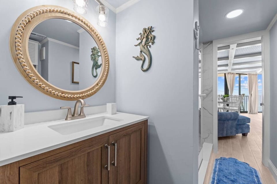 Bathroom Vanity – Modern vanity with seashell mirror and coastal accents.