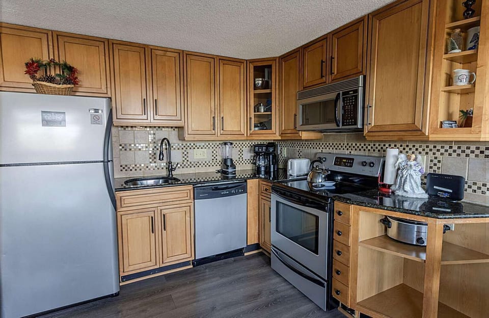 The kitchen features all appliances and gadgets to make home-cooked meals! 