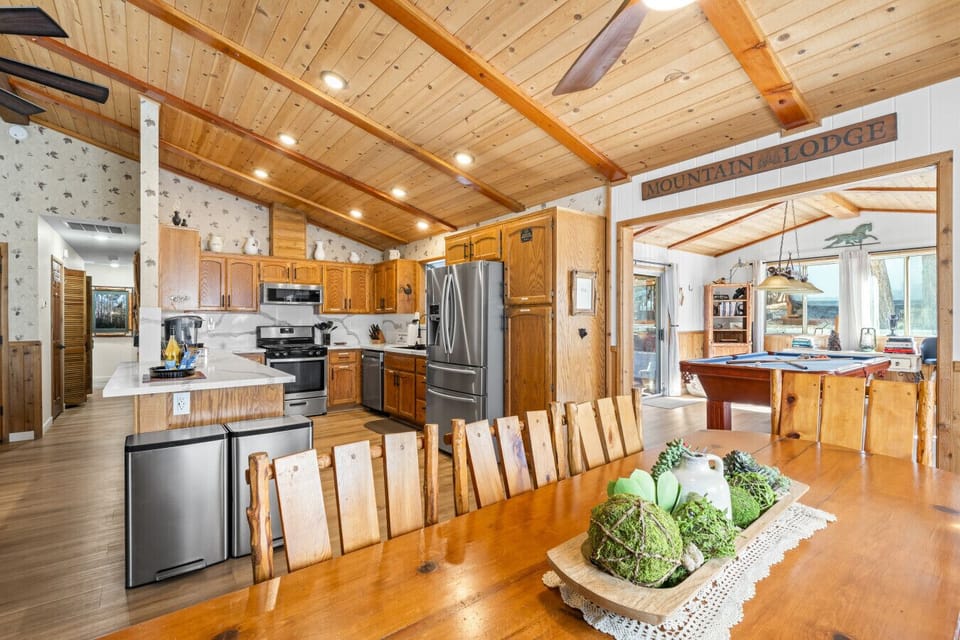 Bright kitchen w/ stainless steel appliances, generous counter space & vaulted ceilings.