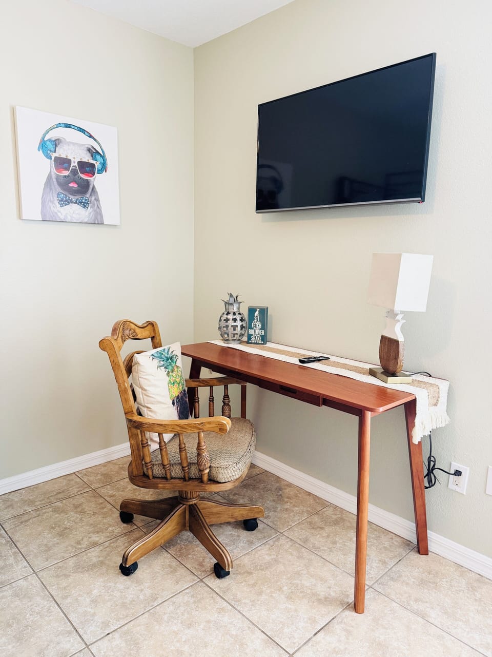 Bonus workspace and TV in the bunk room, complete with pug art for good company.