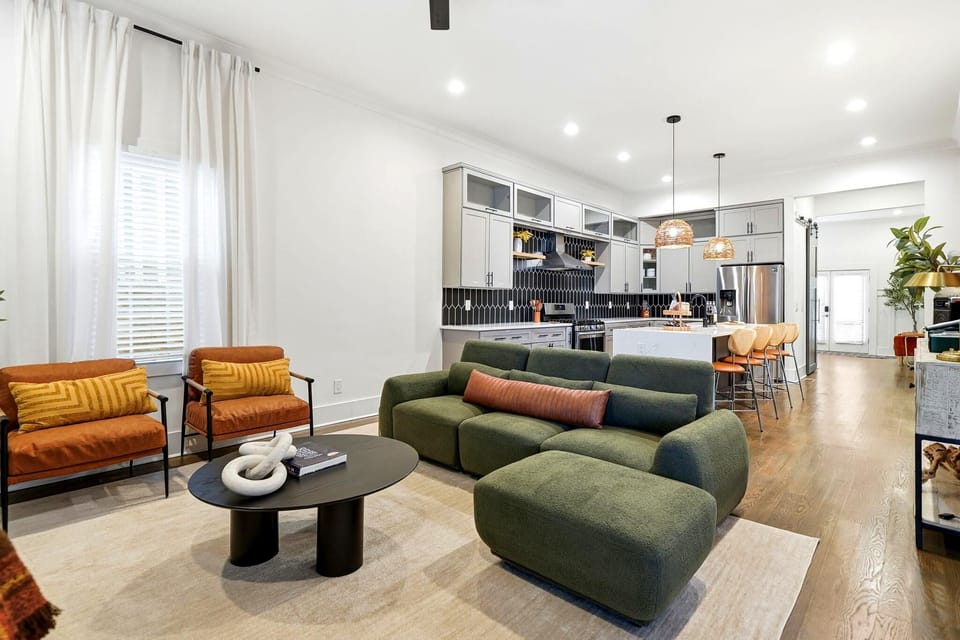Airy, designer-styled living room overlooking the kitchen