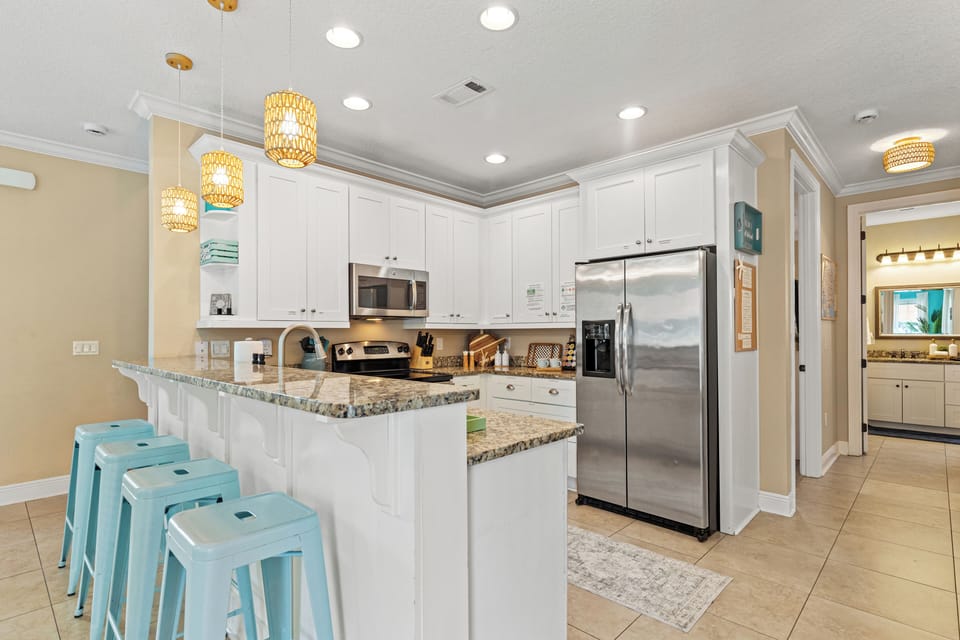 Cook, sip, and connect in this bright coastal kitchen — where morning coffee and evening cocktails flow as easily as the Gulf breeze.
