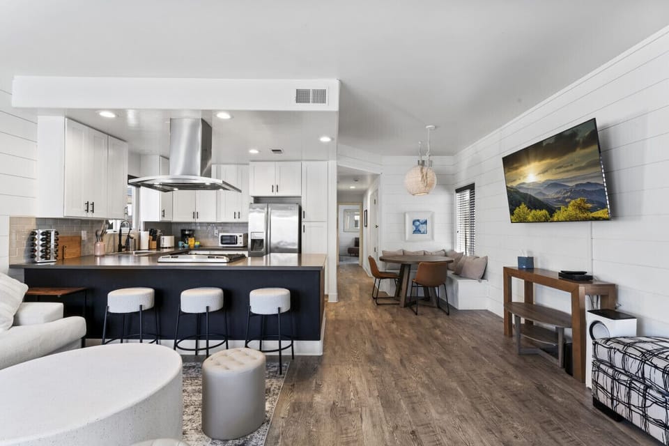 Spacious open-concept living & kitchen area w/ island seating & comfortable lounge space
