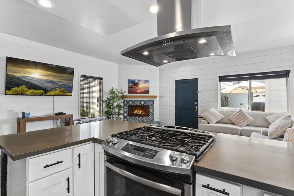 Open kitchen w/ gas cooktop, large island & views into the living area for easy hosting