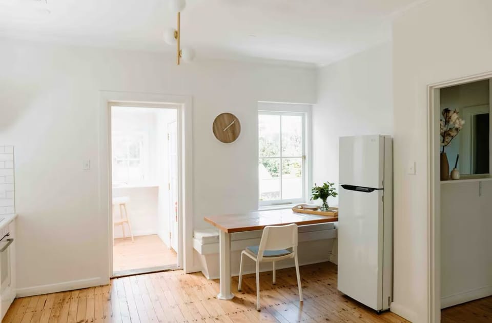Dining area includes a booth which fits 3 people and 2 additional chairs.