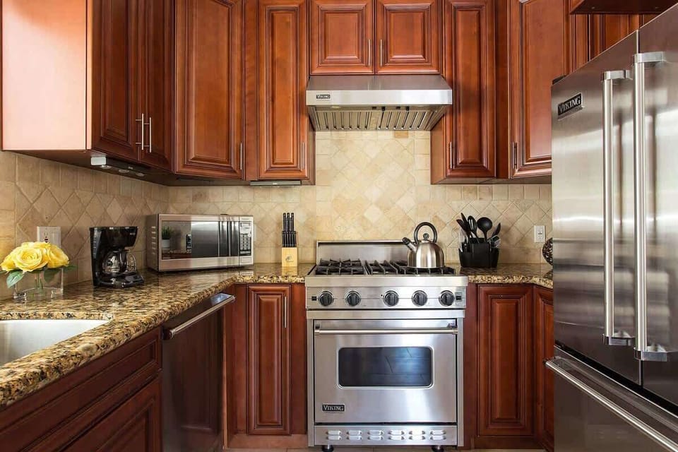 Kitchen with stainless steel appliances and granite counters
