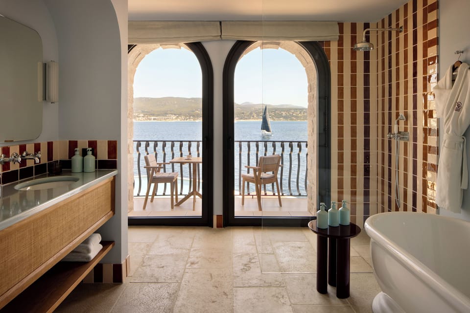 Delos Junior Suite | Bathroom | Rainfall showerhead, hair dryer, bathrobes, slippers