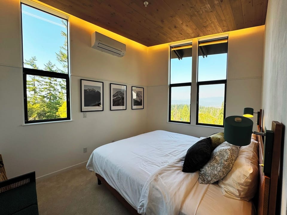 Private suite with windows to ceiling and mountain views.