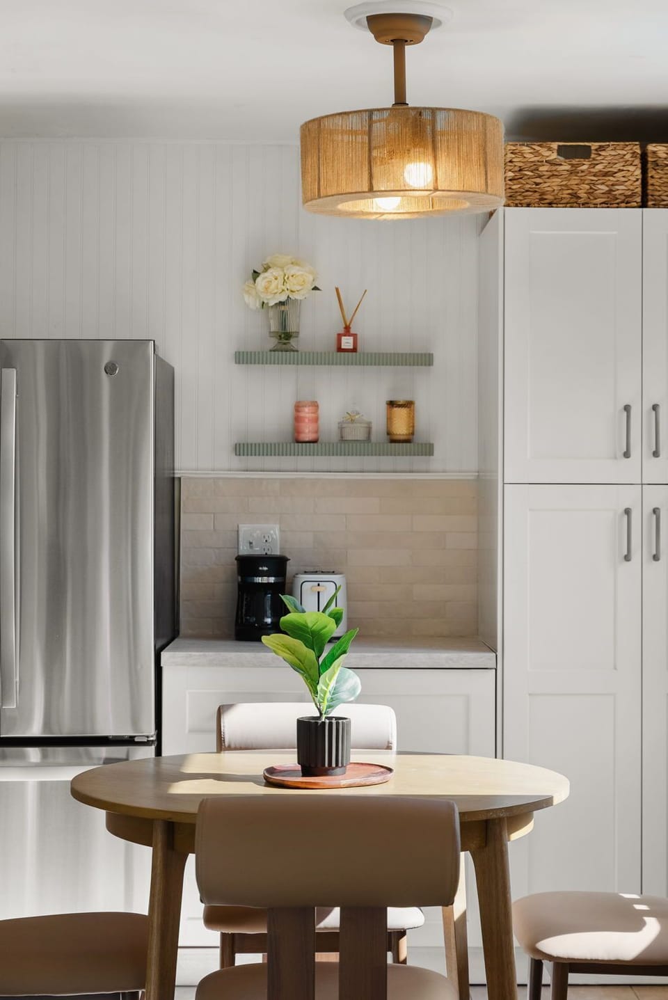 Stylish kitchen corner with cozy dining area and modern appliances.