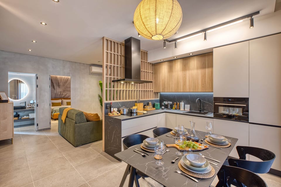 Chef’s kitchen flowing seamlessly into a lush, open-plan space with a soothing ambiance.