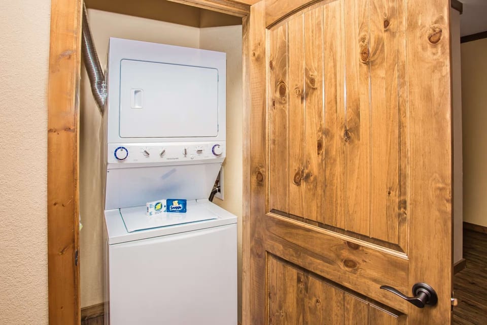 In-suite laundry with stacked washer and dryer for guest convenience.