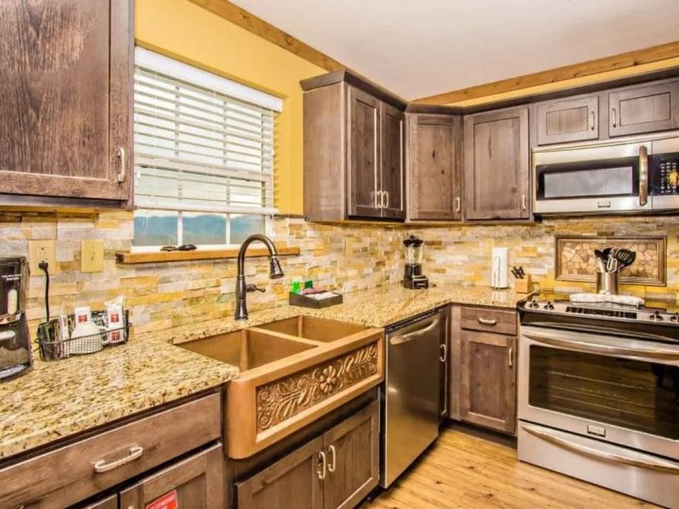 Fully equipped kitchen with granite counters and stainless steel appliances.