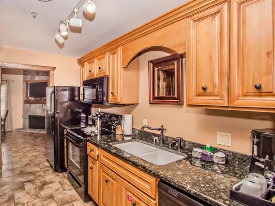 Fully equipped kitchen with stove, microwave, and other appliances for convenient meal prep.