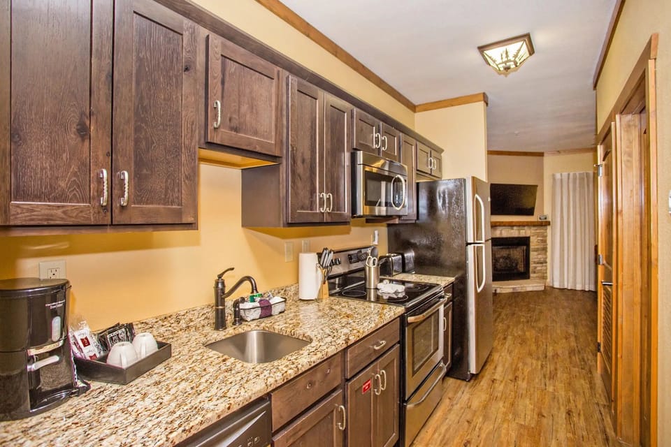 Fully equipped kitchen with microwave, stove, and refrigerator.