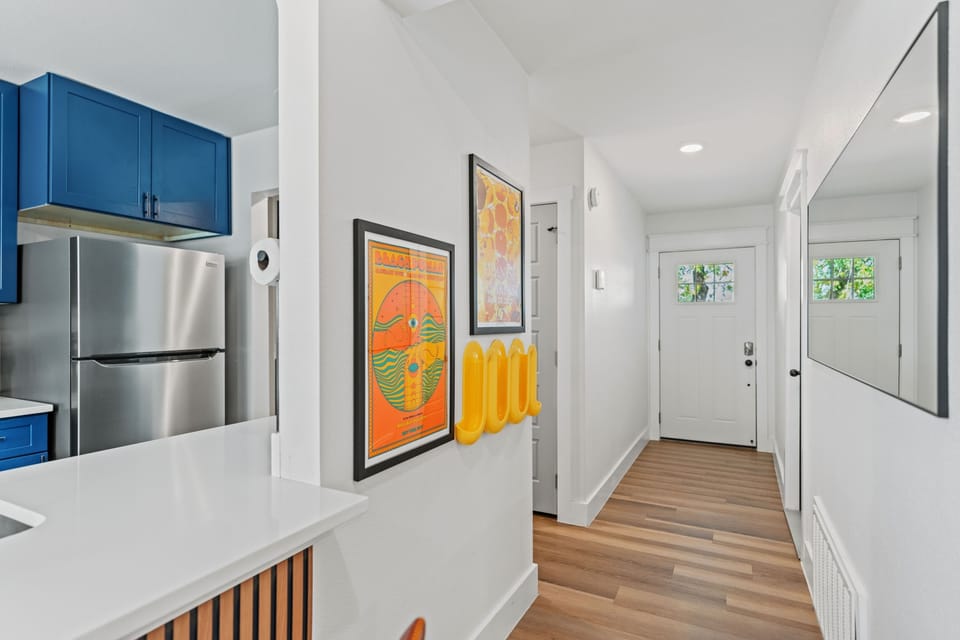 Bright entryway with modern touches and colorful art accents that set the tone for a cheerful Austin stay.