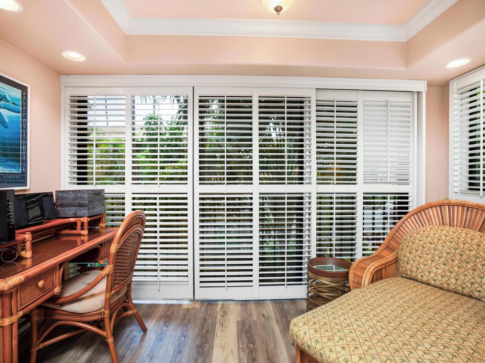 Primary Bedroom (Sleeps 2): Features a plush king-sized bed, a dedicated work desk, and a quiet garden setting.